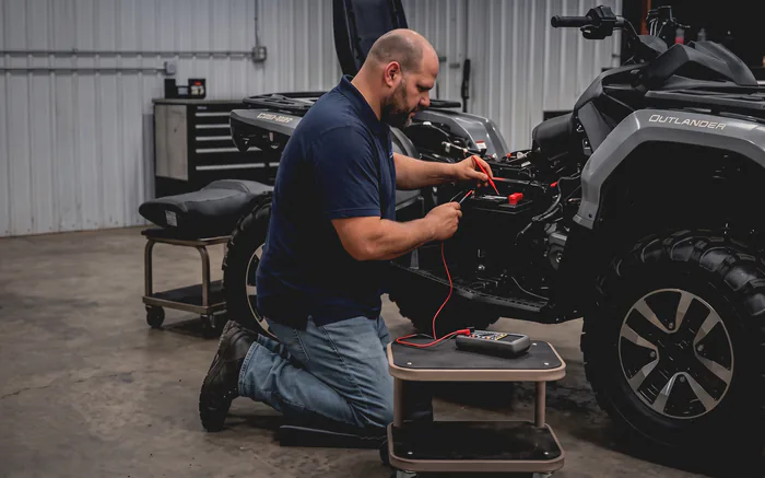 A Lakeview mechanic taking a voltage reading on a Can-Am Outlander in the workshop