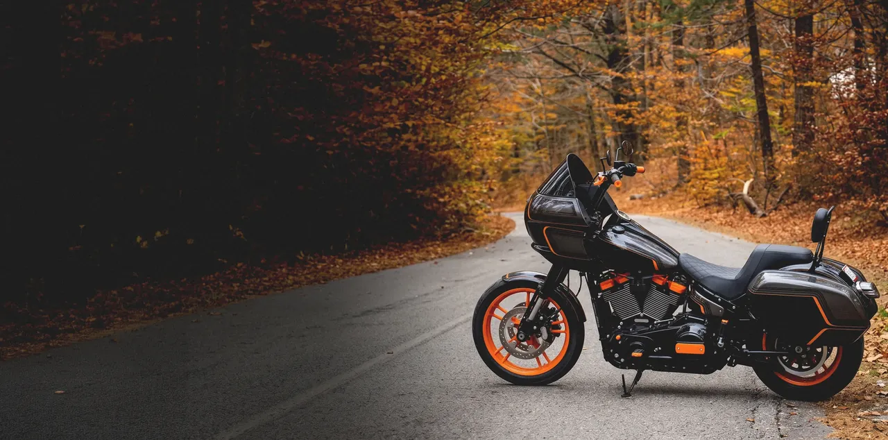 A repaired Harley-Davidson parked on an autumn forest road in the Haliburton Highlands